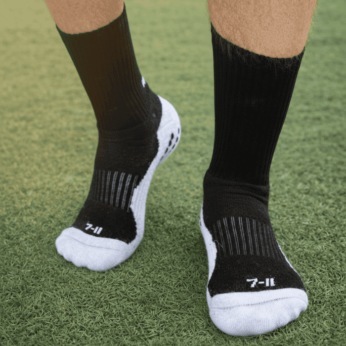 EV2 Black and White Grip Socks on grassy field pictured from top of foot