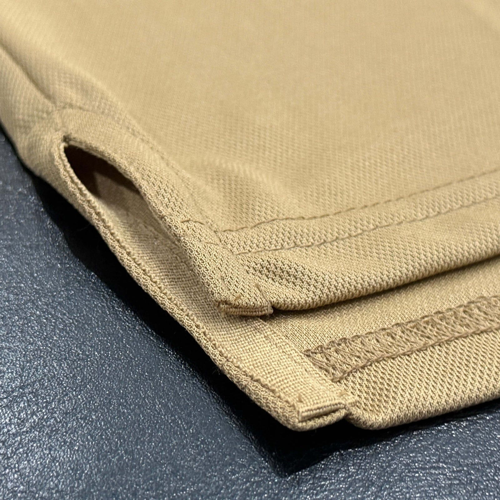 Ventilation slits on either side of the EV2 Fairway Polos in Camel background.