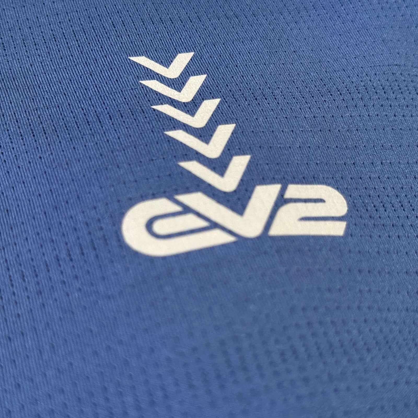 EV2 Masters polo neck logo close up.