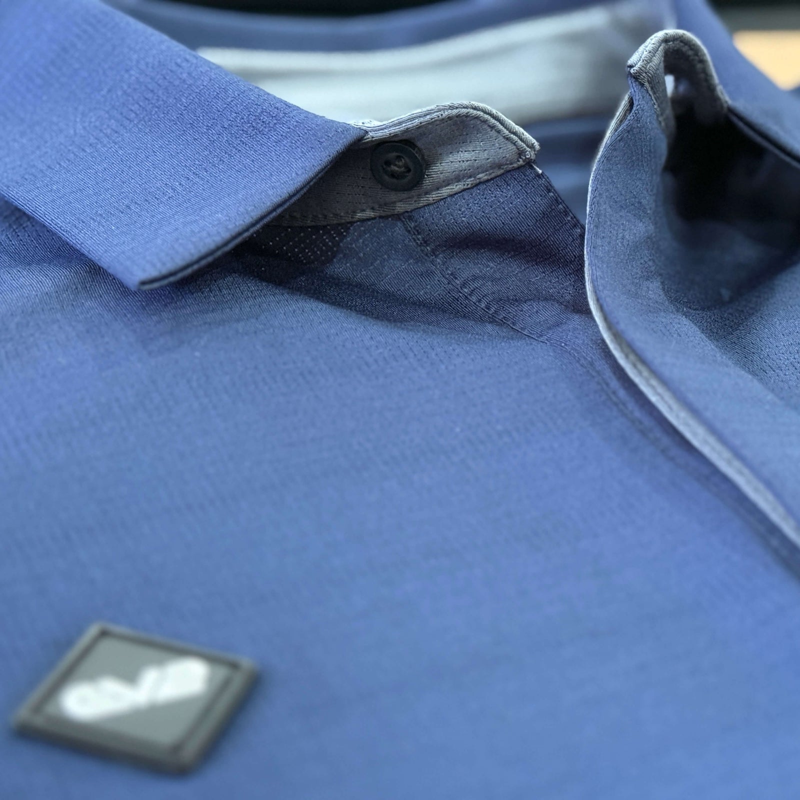 Close up of an EV2 Navy Masters polo's collar.